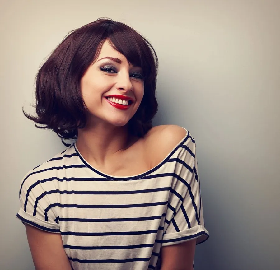 A smiling guest with a glossy chin-length bob
