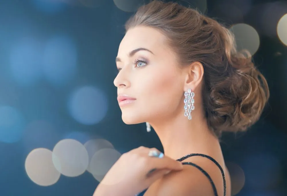 An elegant swept-up hairstyle with sparkling earrings, ready for an evening out